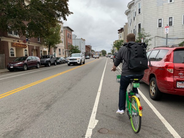The author and his giant backpack biking through South Boston