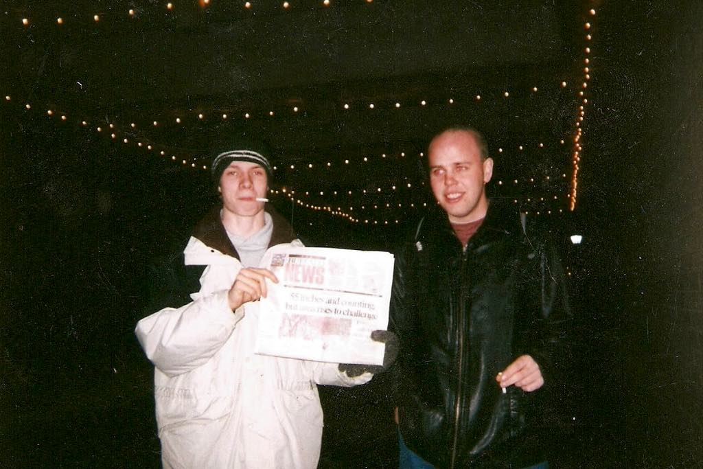 The author holding a copy of the Buffalo News, headline reading 55 Inches and Counting but Area Rises to Challenge