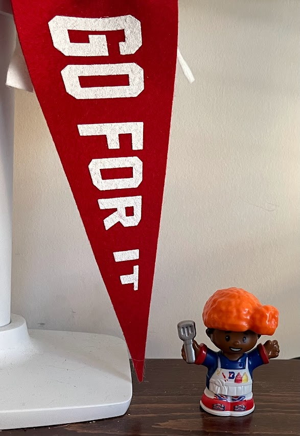 Bills Little People with chicken wing hat, placed underneath Go For It pennant