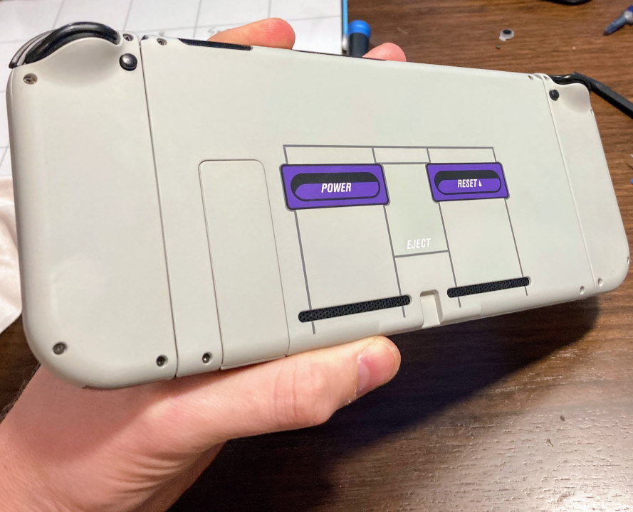 Back of Nintendo Switch modded in SNES style with Power and Reset button images